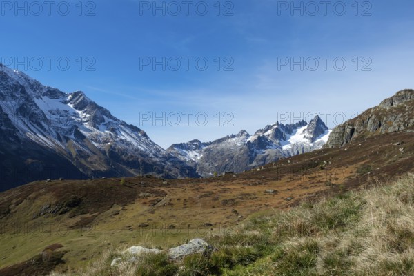 Beautiful autumn landscape in the central Alps, Switzerland. Orange colours and alpine wilderness on a beautiful afternoon