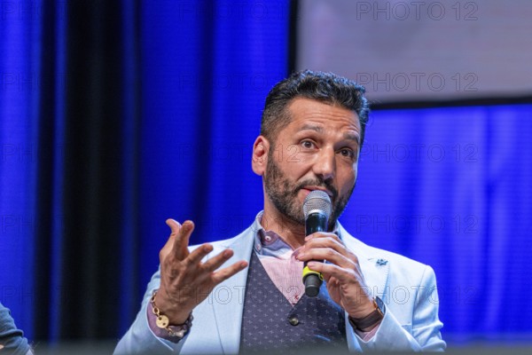 Bonn, Germany, June 8 2019: Cas Anvar (Canadian actor, The Expanse) talks about his experiences in The Expanse at FedCon 28, a four day sci-fi convention. FedCon 28 took place Jun 7-10 2019