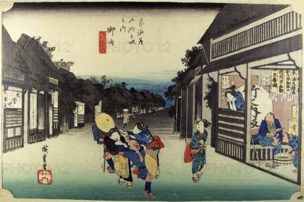 Goyu: Main street of the village at nightfall and female touts dragging travellers into the teahouse on the right, where one is already resting. The large circle on the wall bears the sign of the publisher of the series, Take-no-Uchi. On the signboard inside are given the names of the engraver, Jirobei, the printer, Heibei, and the artist, Ichiryusai. This station was lined with many inns and restaurants. The waitresses were renowned for their persistence in trying to entice customers into their shops.<br/><br/> Utagawa Hiroshige (?? ??, 1797 – October 12, 1858) was a Japanese ukiyo-e artist, and one of the last great artists in that tradition. He was also referred to as Ando Hiroshige (?? ??) (an irregular combination of family name and art name) and by the art name of Ichiyusai Hiroshige (?????).<br/><br/> The Tokaido (??? East Sea Road) was the most important of the Five Routes of the Edo period, connecting Edo (modern-day Tokyo) to Kyoto in Japan. Unlike the inland and less heavily...