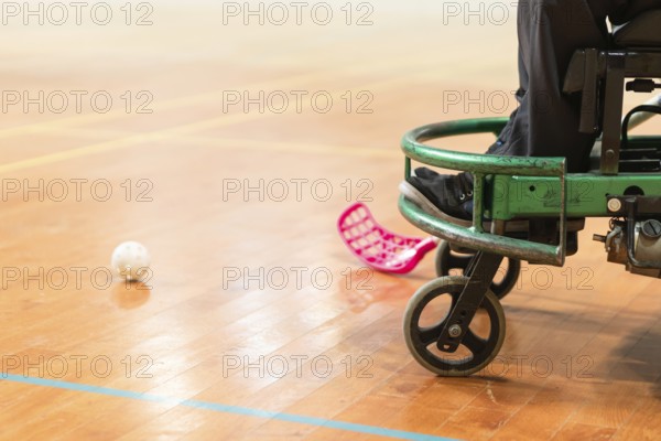 Photo of disabled man on a wheelchair playing sports, hockey, International wheelchair amputee sports IWAS powerchair hockey