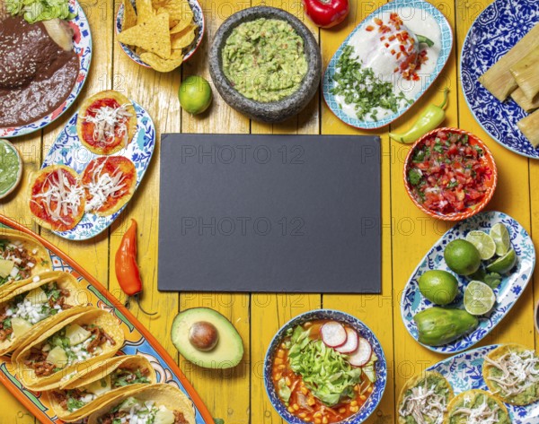 Food, Mexican festive food for independence day, independencia chiles en nogada, tacos al pastor, chalupas pozole, tamales, chicken with mole poblano sauce. Yellow background