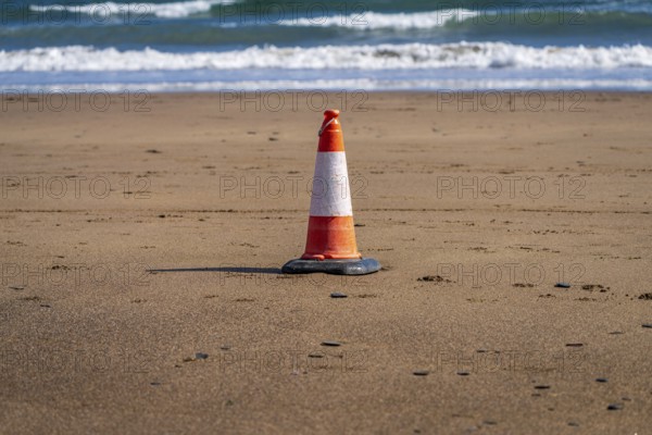 A single pylon on the beach