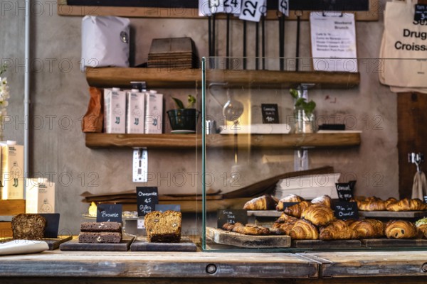 Madrid, Spain, October 17, 2020: Interior of hipster cafe with fresh bakery on counter