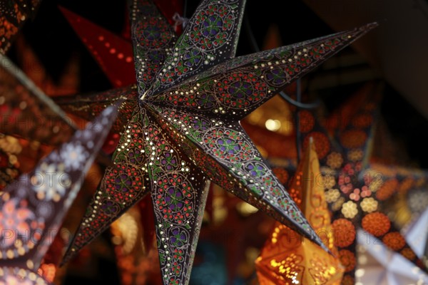 Decorative, illuminated stars with an artistic pattern create a warm, Christmassy atmosphere at a Christmas market, Cologne, North Rhine-Westphalia, Germany