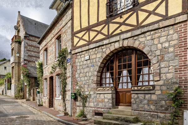 Charming stone and half-timbered houses with large windows in an old street, The historic mill village of Veules Les Roses in Normandy, France