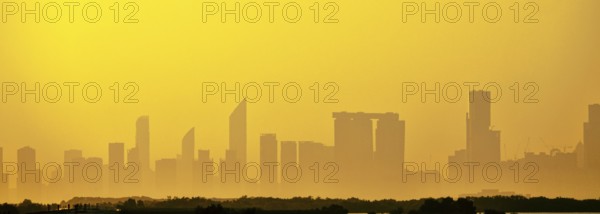 Sandstorm, samum, haboob over the southern megalopolis, the outline of skyscrapers are drowning in yellow haze. Abu Dhabi