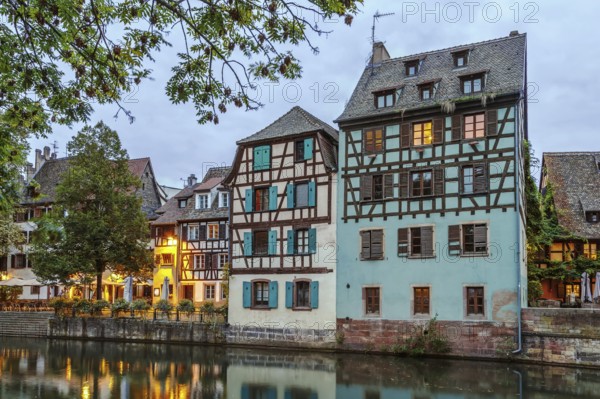 Historic houses on the embankment of the Ill river in Petite France district in Strasbourg, France. Evening