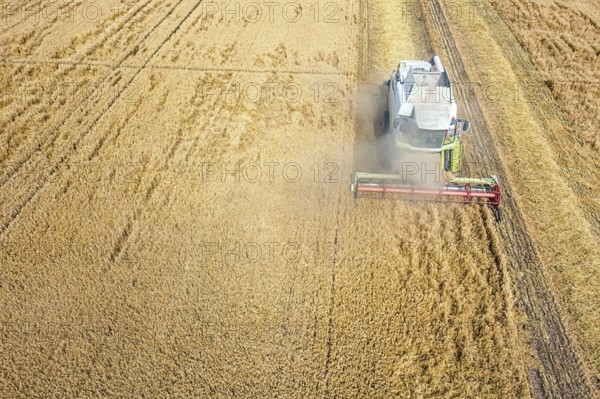 Combine harvester working on a wheat field. Combine harvester Aerial view