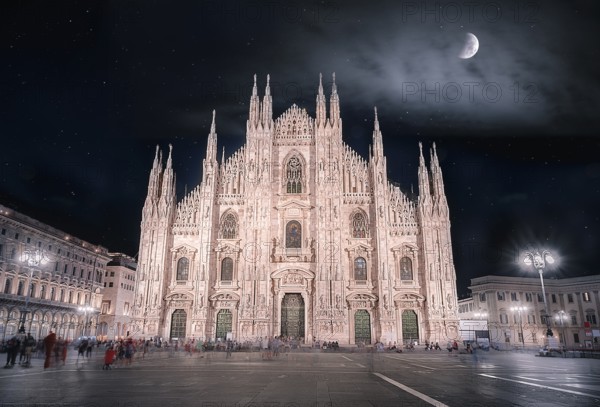 Night picture with the Cathedral of Milan, known also as the Duomo of Milan, with a beautiful sky full of stars and enlightened by the moon