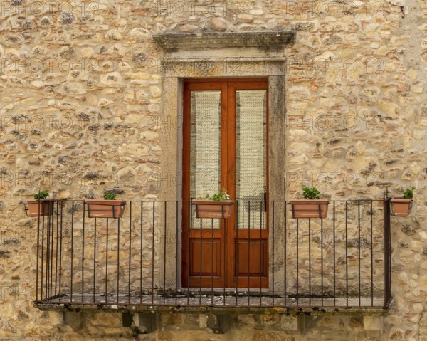 The window and the balcony of an ancient Sicilian medieval house