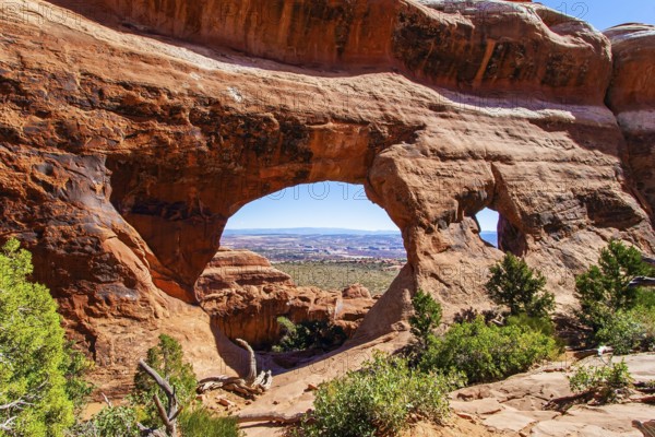 Double O Arch. The beauty of Arches Park in USA. Picturesque red-brown sandstone cliffs form a unique landscape. Grandiose rock compositions natural origin