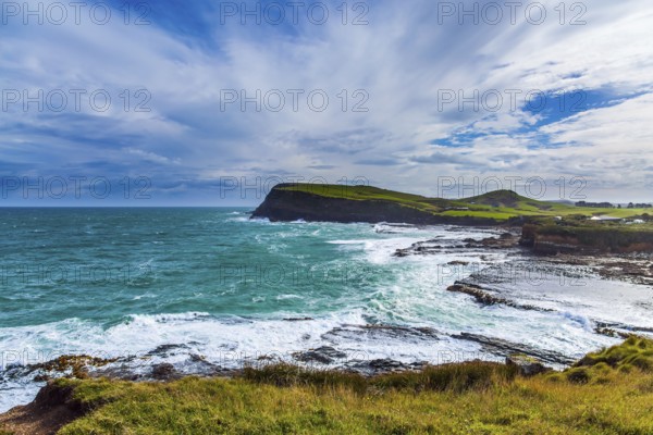 The majestic and cold beauty of the New Zealand south. Caitlins Scenic Road. Sunset of South island. Rocky and stone shores of the ocean. The concept of ecological and photo tourism