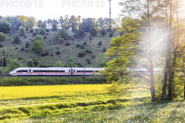 InterCityExpress ICE travelling across the Swabian Alb. Idyllic landscape in spring. Lonsee, Baden-Württemberg, Germany