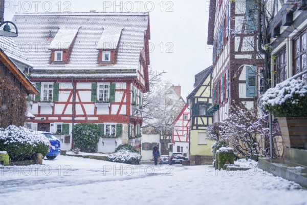 Snow-covered village street with half-timbered houses and a peaceful winter atmosphere, Sindelfingen, Germany