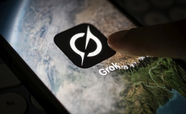 In this photo illustration, a person uses Grok AI chatbot on a mobile phone on March 21, 2025 in Guwahati, India. Elon Musk's AI chatbot, Grok, has recently become a topic of significant discussion in India due to its use of Hindi slang and unfiltered language in its responses