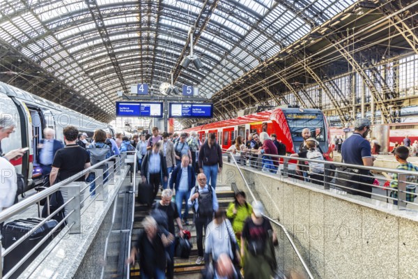 Cologne Central Station. Stairs to the platforms. Travellers waiting for their train on the platform. Crowd with motion blur. Cologne, North Rhine-Westphalia, Germany