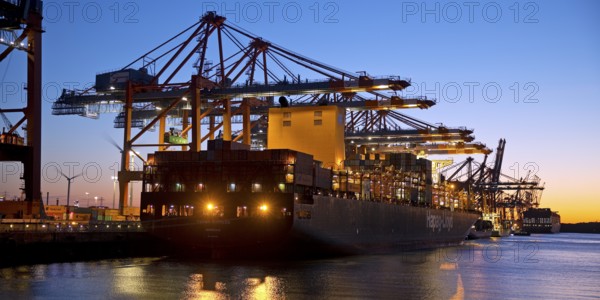 Container ships at the Eurogate container terminal in the evening with an atmospheric sunset, harbour, Hamburg, Germany