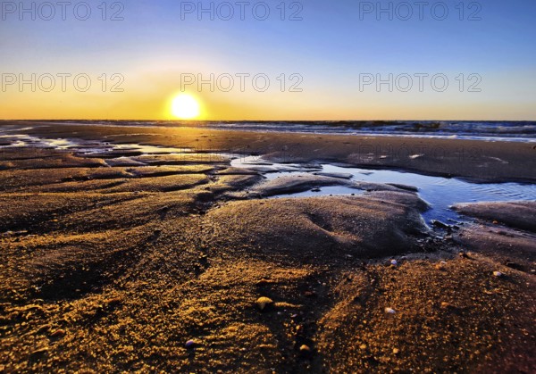 Atmospheric sunrise over the mudflats with the North Sea, Wyk auf Föhr, North Frisia, Schleswig-Holstein, Germany