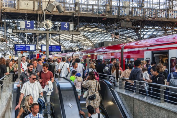 Cologne Central Station. Stairs to the platforms. Travellers waiting for their train on the platform. Crowd with motion blur. Cologne, North Rhine-Westphalia, Germany