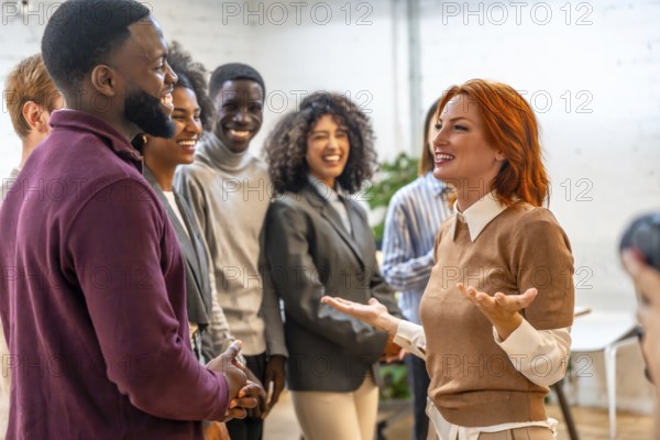 New member of a coworking team presenting herself to diverse colleagues in the office