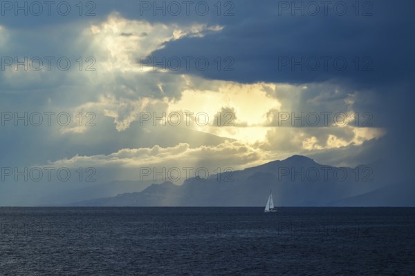 Sun rays in the clouds over Sicily, Tyrrhenian Sea, Italy