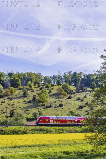 RegionalExpress RE5 to Friedrichshafen travelling over the Swabian Alb. Idyllic landscape near Lonsee in spring. Lonsee, Baden-Württemberg, Germany