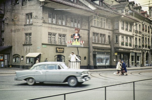 Chevrolet car passes a policeman directing traffic in the city of Bern, Switzerland, Europe 1961