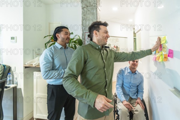 Business colleagues discussing ideas written on sticky notes during a productive meeting in a modern office