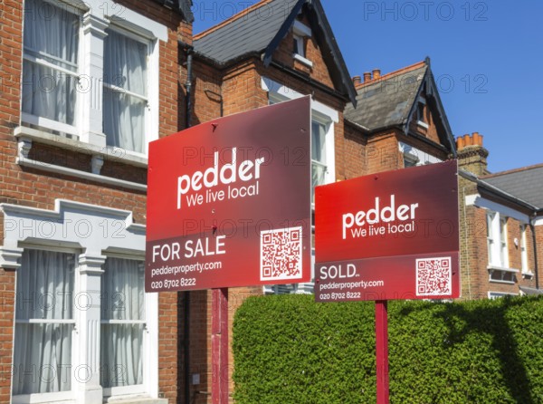 Estate agent property signs outside houses for sale, Barry Road, East Dulwich, London SE22, England, UK