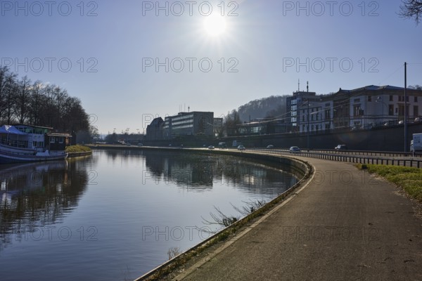 River Saar, footpath and cycle path, riverbank, trees, general architecture, reflections on the water surface, backlight of the sun, blue sky, cloudless, motorway A620, Saarbrücken, state capital, regional association Saarbrücken, Saarland, Germany