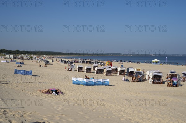 Beach chairs and tourists on the sandy beach, Swinemünde, Usedom Island, Baltic Sea, Poland