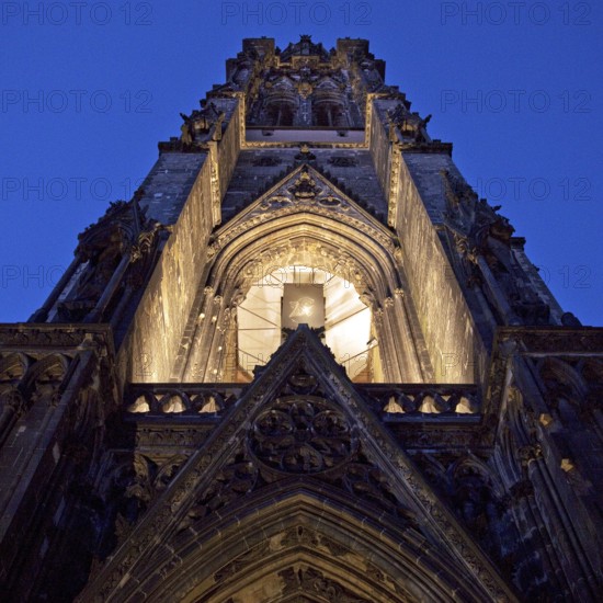 Illuminated church tower of the St. Nikolai memorial, ruins of the former main church of St. Nikolai, Hamburg, Germany