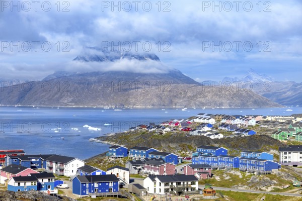 Panoramic view of Greenland capital Nuuk with colored houses located near fjords and icebergs