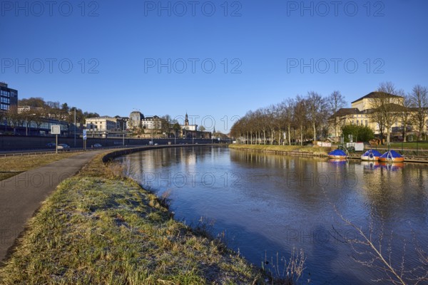 River Saar, bank, trees, meadow, reflections on the water surface, footpath and cycle path, Saarland State Theatre, frog's-eye view, blue sky, cloudless, A620 motorway, Saarbrücken, state capital, Saarbrücken Regional Association, Saarland, Germany