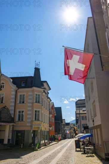 City Street with Houses and a Shop on the Mountain in a Sunny Summer Day in Andermatt, Uri, Switzerland.