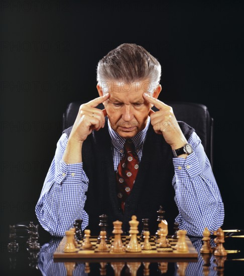 A man plays chess and thinks, 60, years, seniors, senior studio shot, Lower Saxony, Federal Republic of Germany