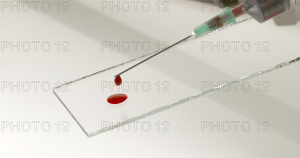 Blood dropping from Needle against White Background
