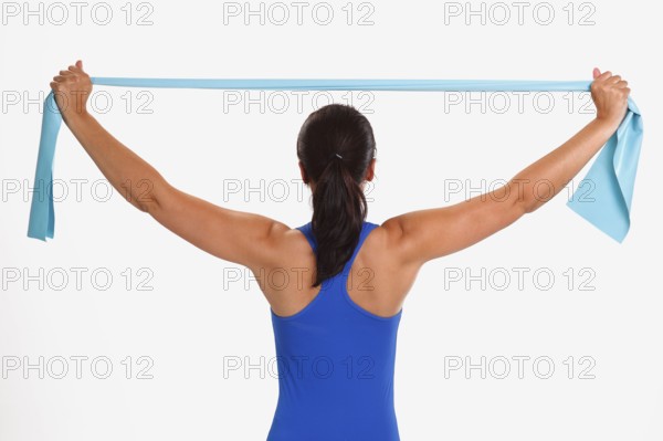 Woman doing sports exercise with Thera-Band, sports exercises