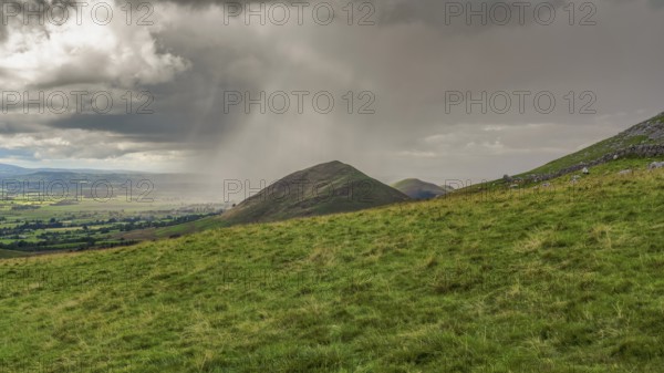 North Pennines landscape, looking at the rain clouds over Dufton Pike in Cumbria, England, UK