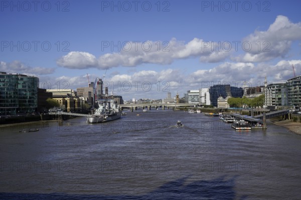 View of the River Thames from Tower Bridge in the City of London with bridges and modern architecture under a blue sky, London SE1 2UP, England, United Kingdom
