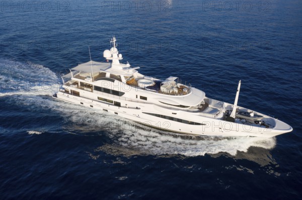 Aerial view of 55-metre motor yacht HALO, delivered in 2018 by the Dutch shipyard Amels, cruising off the Principality of Monaco, French Riviera, Mediterranean Sea