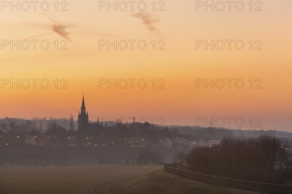 Sunset with the Briesnitz church, large amounts of Sahara dust colour the evening sky particularly red, Dresden, Saxony, Germany