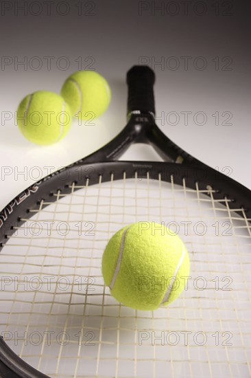 Tennis balls three green color with tennis racket racquet