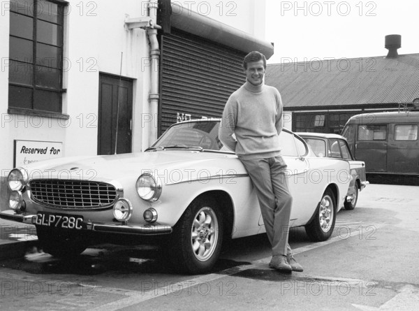 Volvo P1800. A sports car manufactured by Volvo Cars wtih production start 1961 and ending 1973. Styling was by swedish designer Pelle Pettersson. The car was indroduced at the Geneva Motor Show in 1961. The model P1800 sold 47492 cars.The P1800 became widely known when driven by then future James Bond actor Roger Moore as Simon Templar in the television series The Saint. Pictured Sir Roger Moore, 1927-2017 during the filming of the tv-series The Saint, posing with a Volvo P1800. The Saint ran from 1962 for six seasons and 118 episodes. 1966