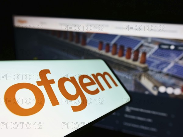 Stuttgart, Germany, 07-15-2022: Mobile phone with logo of Office of Gas and Electricity Markets (Ofgem) on screen in front of website. Focus on left of phone display