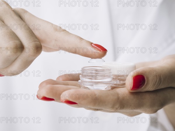 Female pulling out contact lenses from box. Resolution and high quality beautiful photo