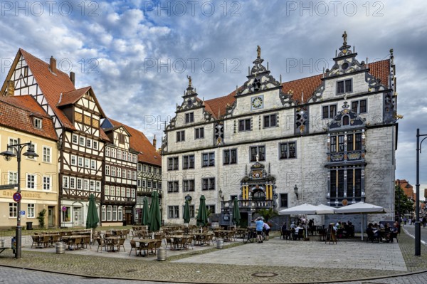 Historic square with half-timbered houses and classic buildings, under a cloudy sky, The historic town hall of Hannoversch Münden in Lower Saxony