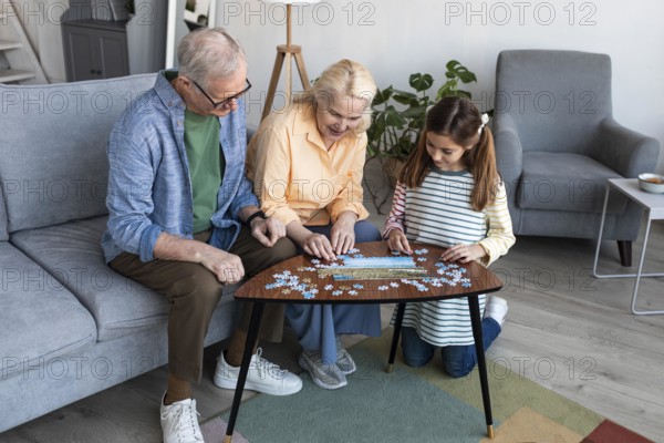 Grandparents girl doing puzzle full shot