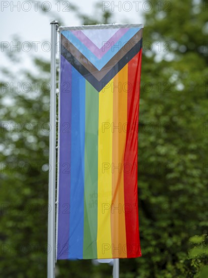 A rainbow flag hangs in front of the building of the Protestant Church of the Palatinate on Domplatz, Speyer, Rhineland-Palatinate, Germany