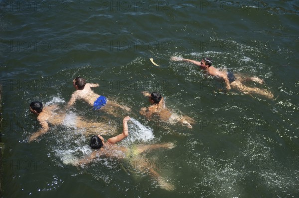 14/06/2018, Porto, Portugal, Europe, Children playing and swimming on the banks of the Duero in Porto